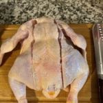 Precise raw chicken ready for cooking with ChefsTemp thermometer in kitchen setting.