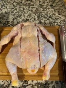 Precise raw chicken ready for cooking with ChefsTemp thermometer in kitchen setting.