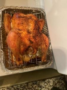 Perfectly roasted whole chicken on a grilling rack, ready to serve.