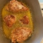 Juicy fried chicken cooking in hot oil for crispy texture and flavor.