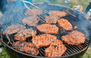 Juicy grilled steaks cooking on a barbecue, perfect for outdoor grilling and culinary enthusiasts.