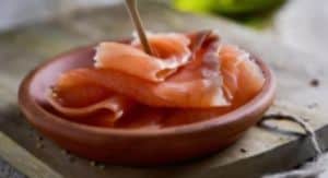 Vacuum-sealed raw chicken breast on a rustic plate, ideal for sous vide cooking.