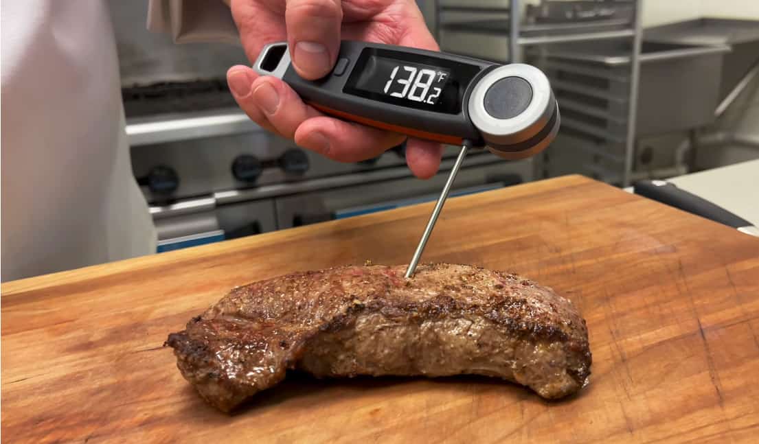 1. Digital meat thermometer checking steak temperature for perfect doneness.