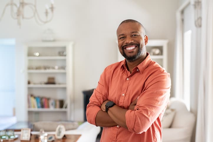 Confident man smiling in casual attire, indoor setting showing ChefTemp kitchen products and tools.