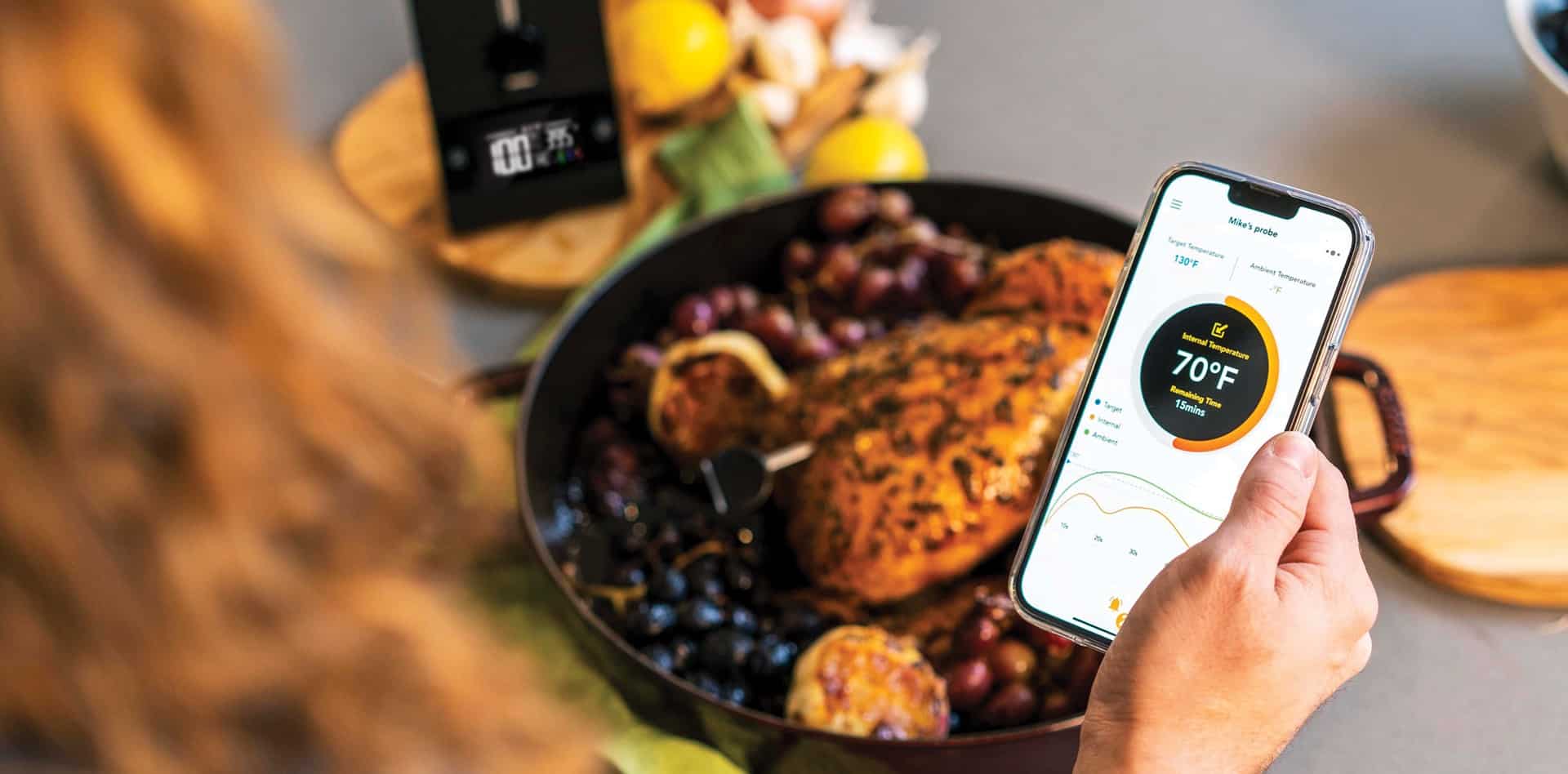 Digital meat thermometer with mobile app for precise cooking control, perfect for chefs and home cooks.