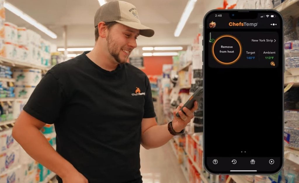 Precision cooking with ChefsTemp wireless thermometer app on smartphone in store.