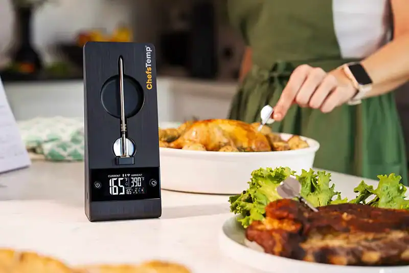 Wireless meat thermometer with digital display for precise grilling.